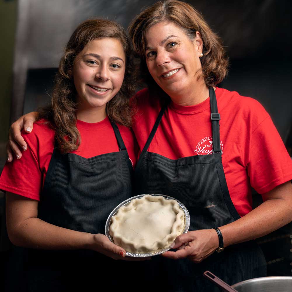 Mother and daughter holding a homemade pie